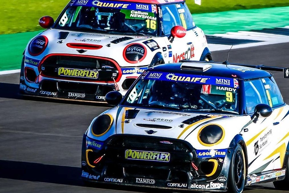 Two Mini Challenge JCW race cars battling on track