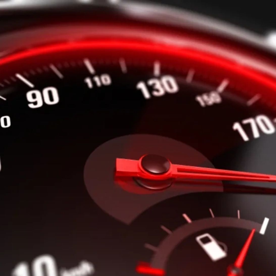 Rev counter and fuel gauge on a race car dashboard